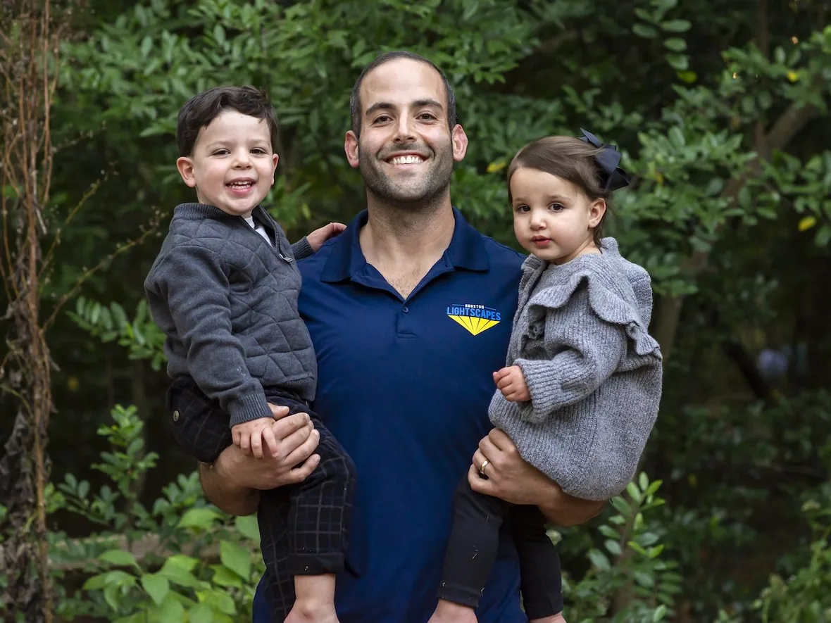 Michael Akerman, owner of Houston Lightscapes, with his two children