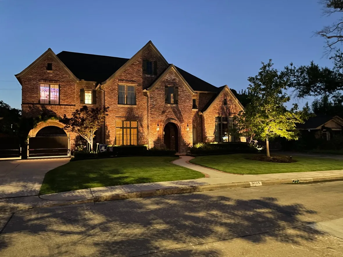 Home lit so that some areas carry the view and others stay deliberately dark