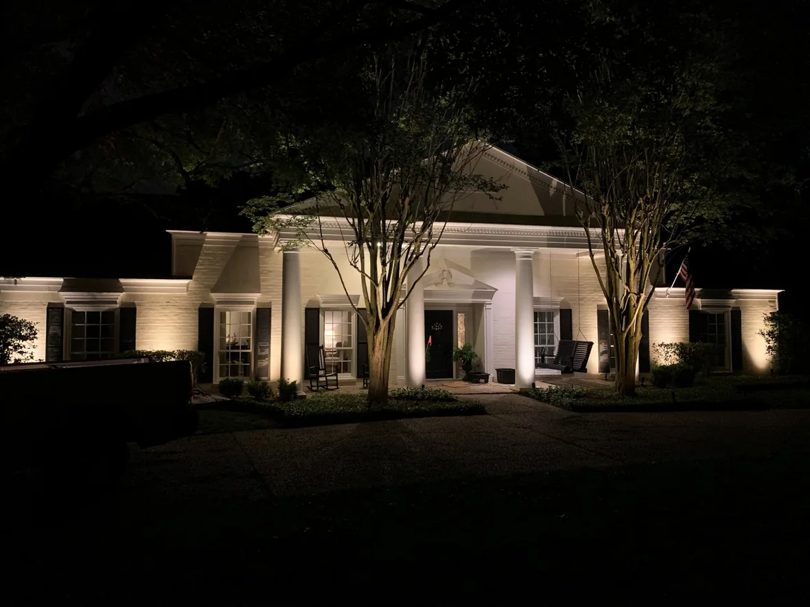 Colonnade and landscaping of a commercial property lit at night