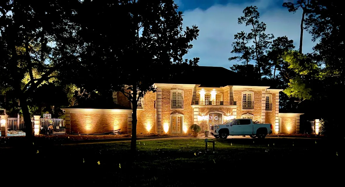 Established landscape lighting system on a Houston property, serviced and adjusted at night